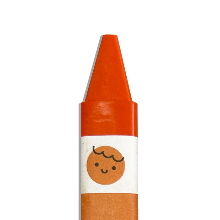Close up of orange OOLY Color Together Triangular Crayons on a white background