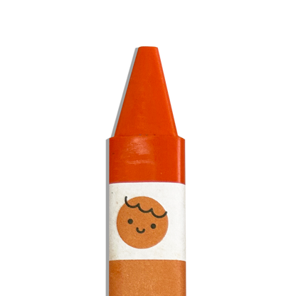 Close up of orange OOLY Color Together Triangular Crayons on a white background
