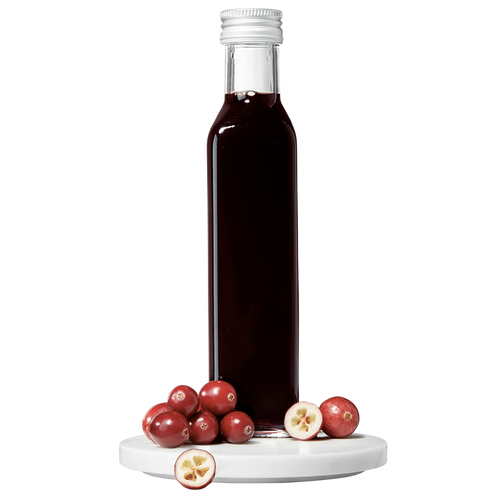 A bottle of Cranberry Balsamic Vinegar with fresh cranberries in front of it.
