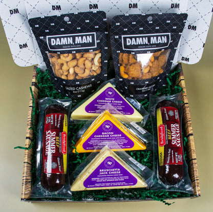 Damn Man Gourmet gift basket with snacks and cheese in a decorative box.
