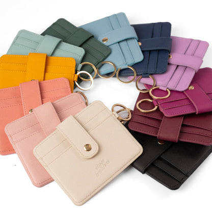 Collection of colorful keychains and card holders on a white background