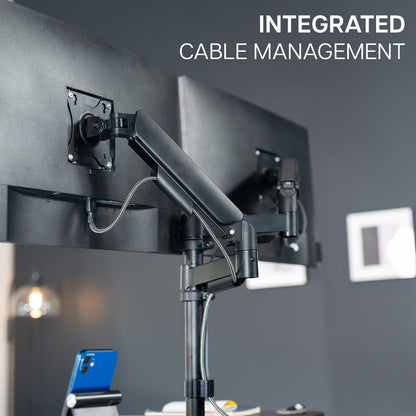 Height adjustable desk riser with articulating mechanical dual monitor mount.