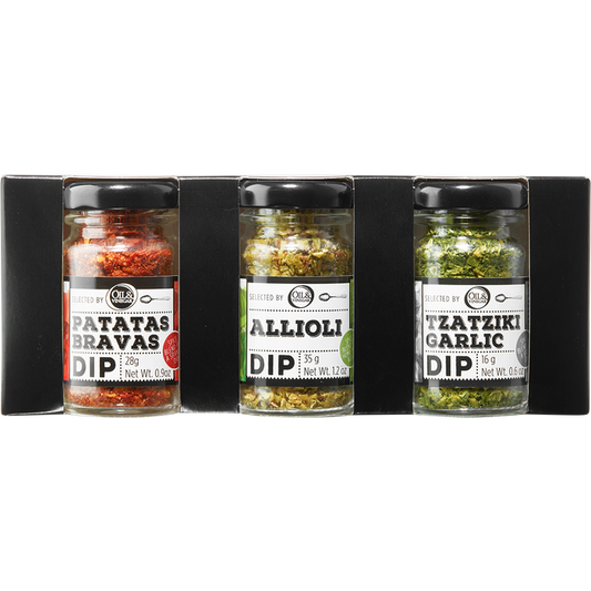 Three glass jars with black lids, labeled as Patatas Bravas Dip, Allioli Dip, and Tzatziki Garlic Dip, arranged side by side.