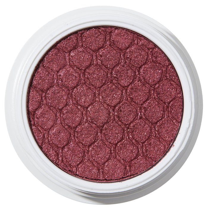 ColourPop Drift Super Shock Shadow displays a metallic cranberry-burgundy shimmer, pressed with a quilted scale pattern, sitting in a round white pot on a plain white studio background.