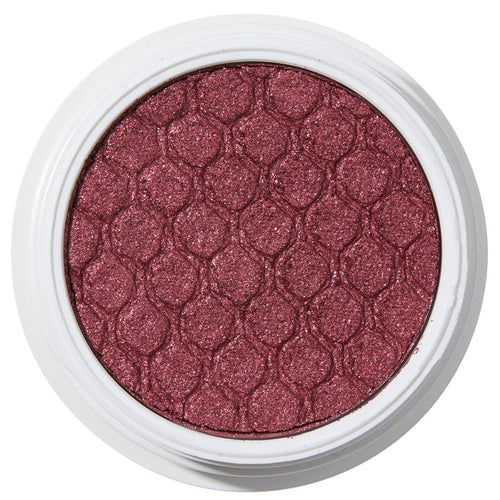 ColourPop Drift Super Shock Shadow displays a metallic cranberry-burgundy shimmer, pressed with a quilted scale pattern, sitting in a round white pot on a plain white studio background.