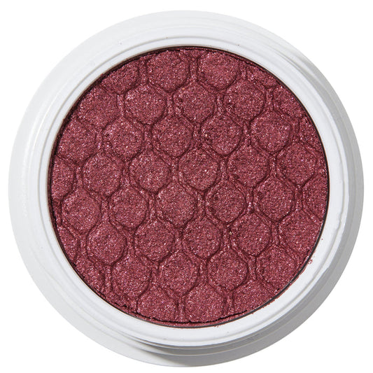 ColourPop Drift Super Shock Shadow displays a metallic cranberry-burgundy shimmer, pressed with a quilted scale pattern, sitting in a round white pot on a plain white studio background.