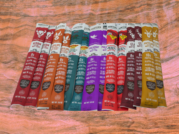 Exotic Meat Sticks Bag with 14 wild beef jerky snacks in vibrant packaging on a textured background.
