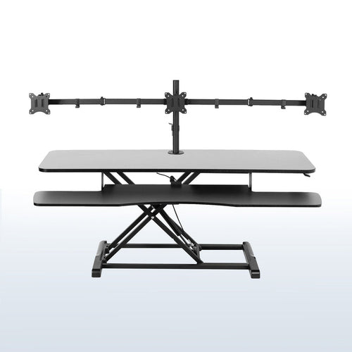 Spacious height adjustable desk riser with articulating triple monitor mount.