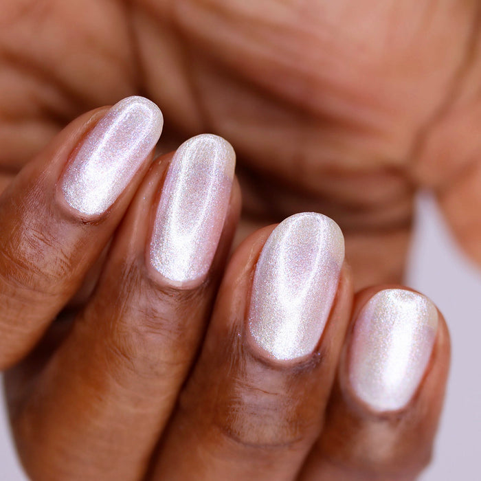 Upside down, close-up of nails painted with Spirit Nail Lacquer on deep skin tone.