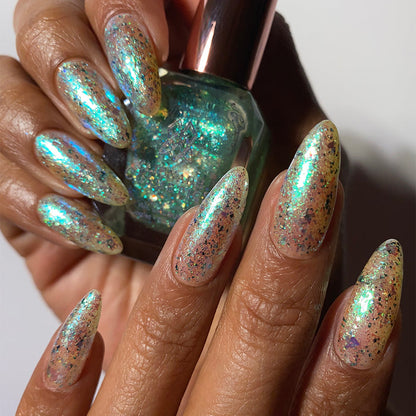 Close-up of nails painted with Fauxjito Nail Lacquer on medium skin tone. Hand is holding polish bottle.