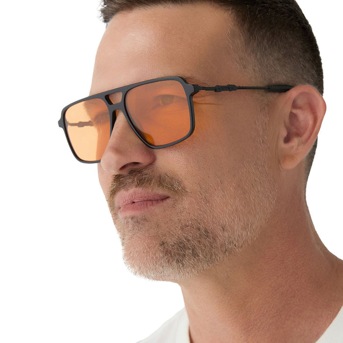 on model - male wearing star wars x diff eyewear fennec shand aviator sunglasses with a black frame and orange lenses side view