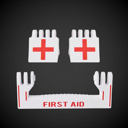 A set of white first aid latches with red text and a red cross symbol on a dark background, including a 'FIRST AID' handle.