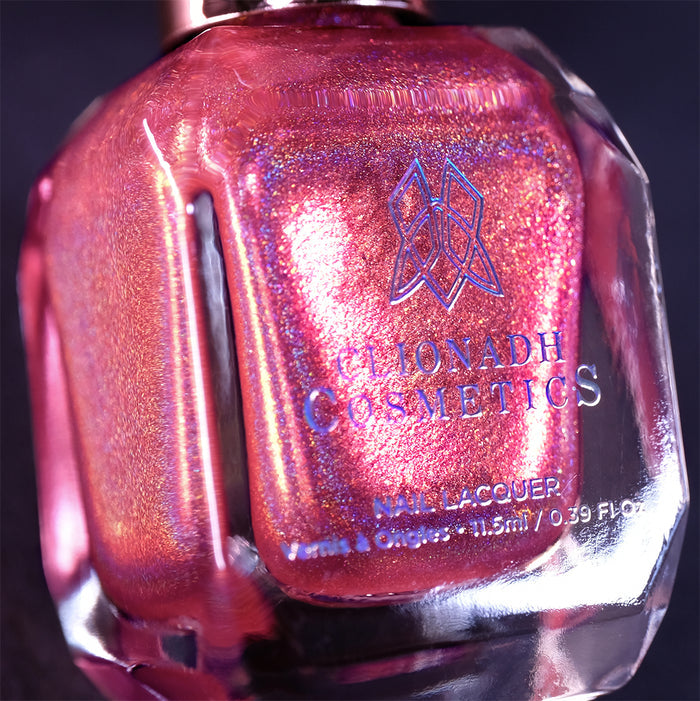 Close-up, angled shot of Flamin' Hot Holo Nail Lacquer bottle on a black background.