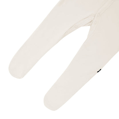 Close up of footed legs and snaps on Kyte Baby Footie in Oat
