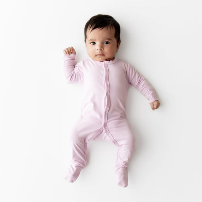 Baby wearing a snap footie in a light purple color