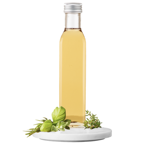 A bottle of Garden Herb Vinegar with a white label and a small green herb sprig on top, set against a transparent background.