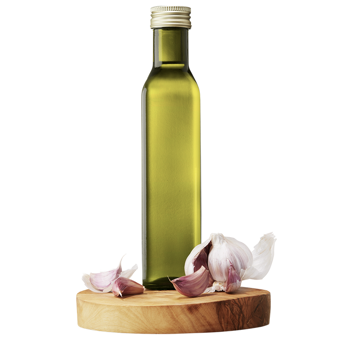 A bottle of Garlic Extra Virgin Olive Oil on a wooden platform with whole garlic cloves around it.