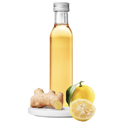 A clear bottle of Ginger Yuzu Vinegar with a lemon and ginger root in the foreground.