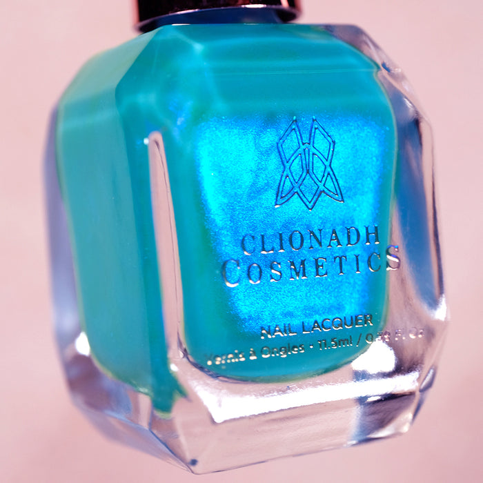 Close-up, angled shot of Ginto Nail Lacquer bottle on a beige background.