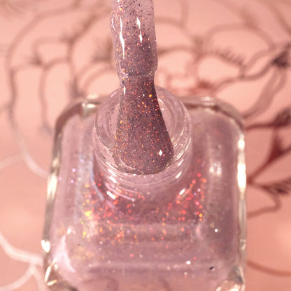 Top-angled, close-up of opened God Speed Nail Lacquer bottle with the brush showing. Emphasizes glitter particles.