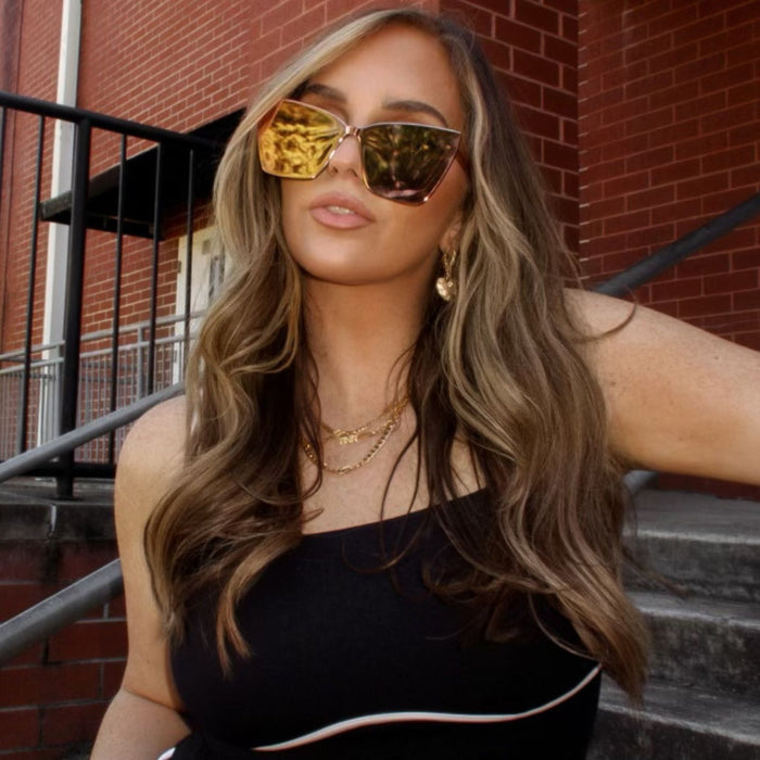 lifestyle - lea sims influencer wearing goldie gold oversized cat eye frame sunglasses