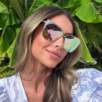 customer content - female wearing diff eyewear grace cat eye sunglasses with a brushed gold frame and cherry blossom mirror lenses