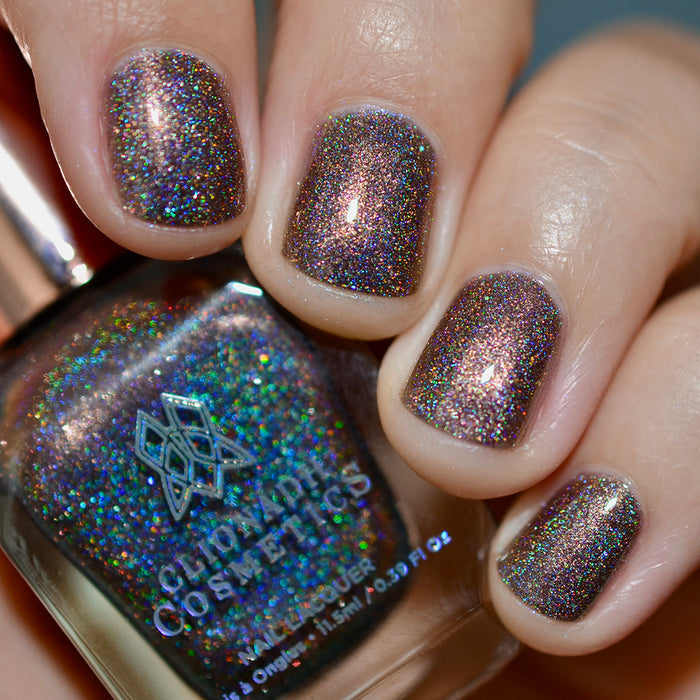 Close-up of nails painted with Graveyard Nail Lacquer on fair skin tone. Hand is holding polish bottle.