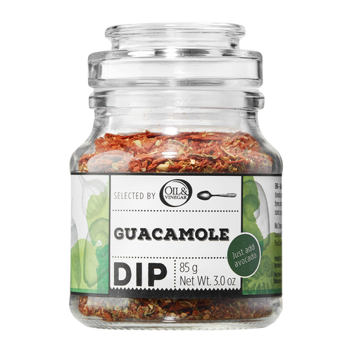A glass jar containing Guacamole Dip with visible herb mix. The label shows the product name and weight.