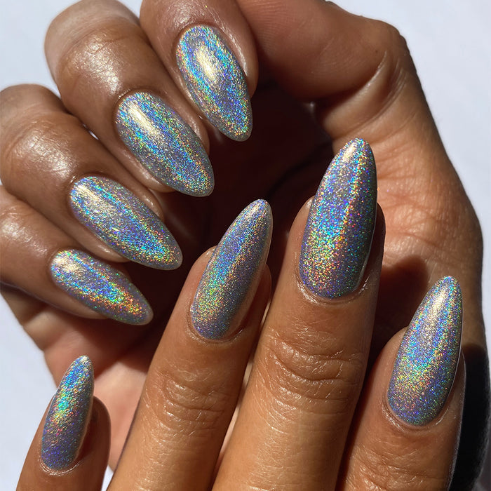 Close-up of nails painted with H₂Olo Nail Lacquer on medium skin tone.