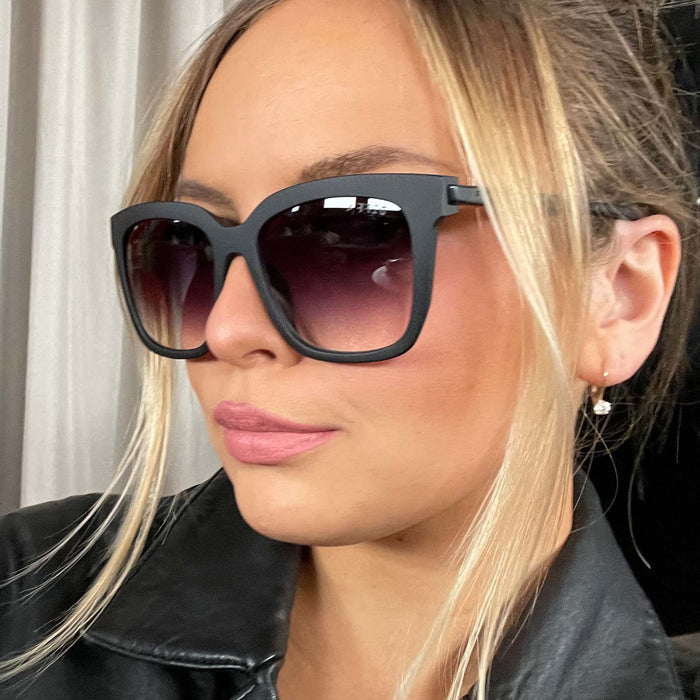 lifestyle - blonde wearing Hailey Matte Black frame with grey gradient sharp lenses