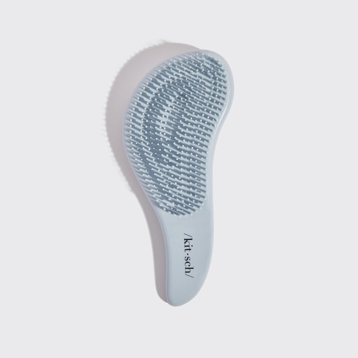 Kitsch Haze Blue Detangling Brush angled view showing bristle base