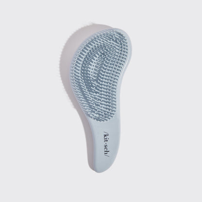 Kitsch Haze Blue Detangling Brush angled view showing bristle base