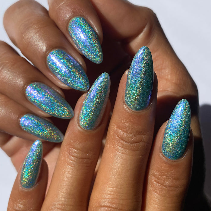 Close-up of nails painted with Holoberry Pie Nail Lacquer on medium skin tone.