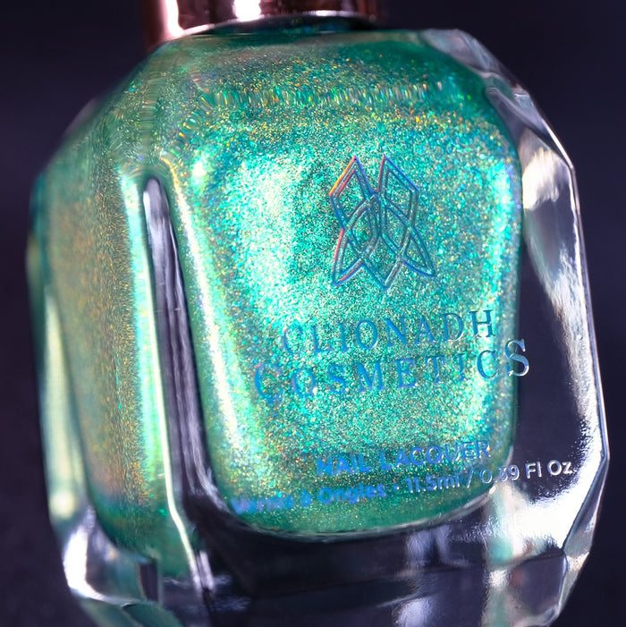 Close-up, angled shot of Holopeño Nail Lacquer bottle on a black background.