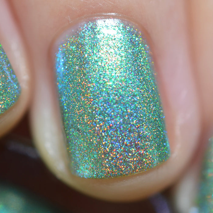 Close-up of one nail painted with Holopeño Nail Lacquer on fair skin tone.