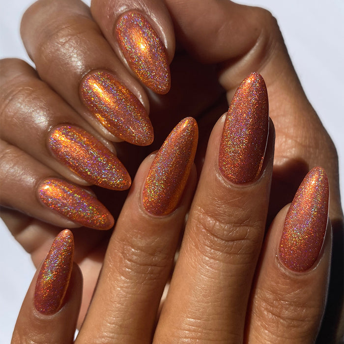 Close-up of nails painted with Holoritos Nail Lacquer on medium skin tone.
