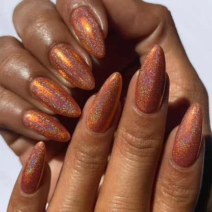 Close-up of nails painted with Holoritos Nail Lacquer on medium skin tone.