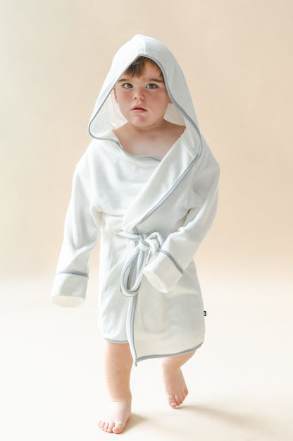 Young boy modeling the Hooded Bath Robe in Cloud with Storm Trim with the hood up