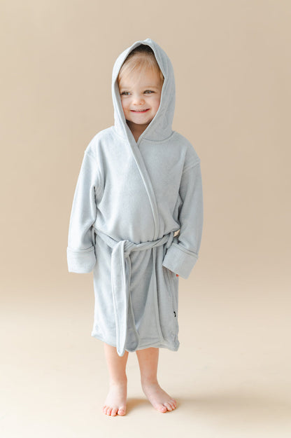Young girl wearing the Hooded Bath Robe in Storm with the hood up