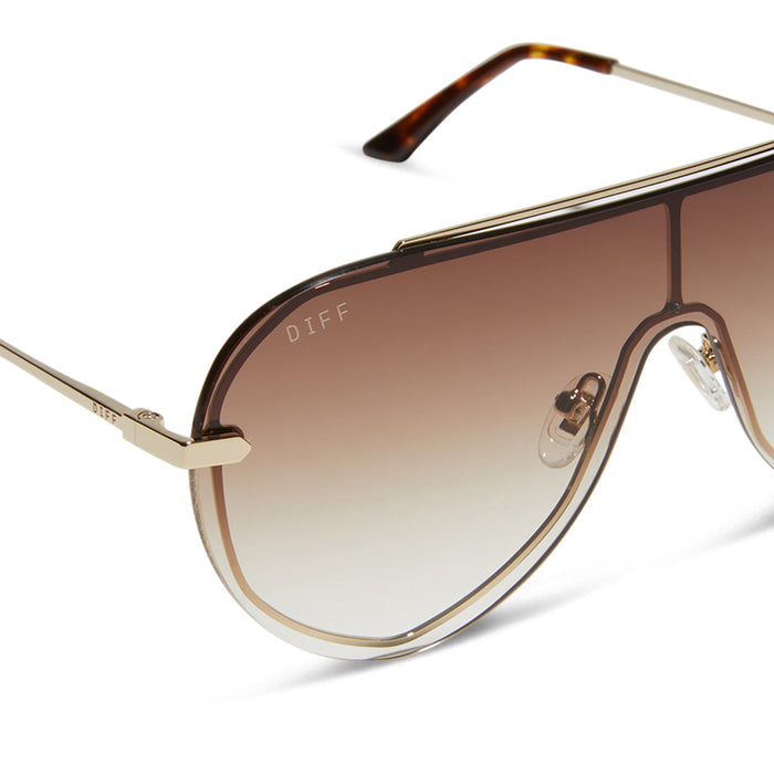 diff eyewear featuring the imani shield sunglasses with a gold frame and brown gradient lenses detailed view