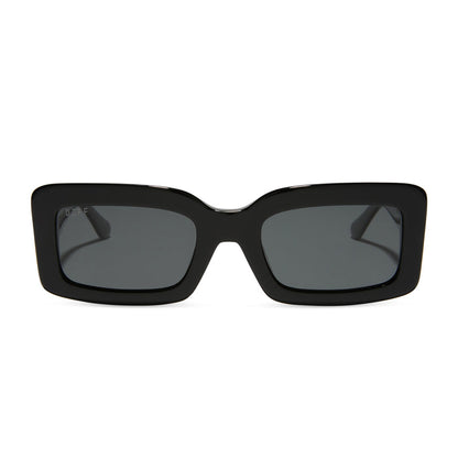 diff eyewear indy rectangular sunglasses with a black acetate frame and grey polarized lenses front view