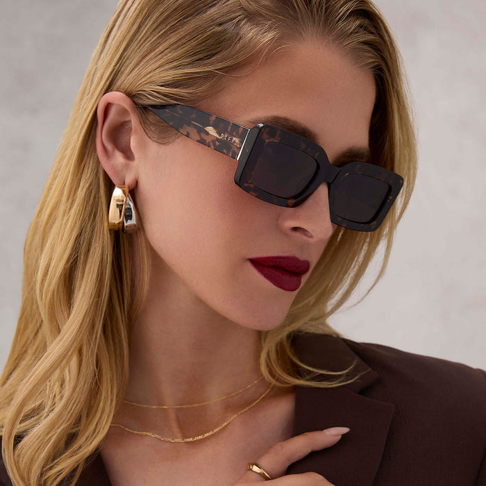on model - female wearing diff eyewear indy rectangular sunglasses with a espresso tortoise acetate frame and grey lenses angled view