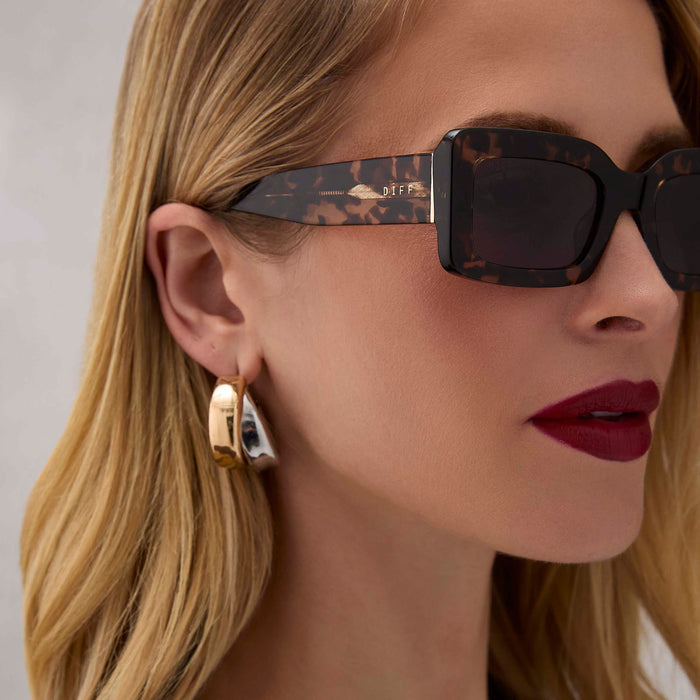 on model - female wearing diff eyewear indy rectangular sunglasses with a espresso tortoise acetate frame and grey lenses detailed view