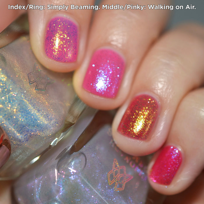 Close-up of nails painted with Simply Beaming and Walking on Air Nail Lacquers over a pink base on fair skin tone.