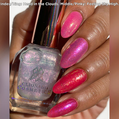 Close up shot of nails done with Head in the Clouds and Feeling Sky High Nail Lacquers over a pink base on medium skin tone.