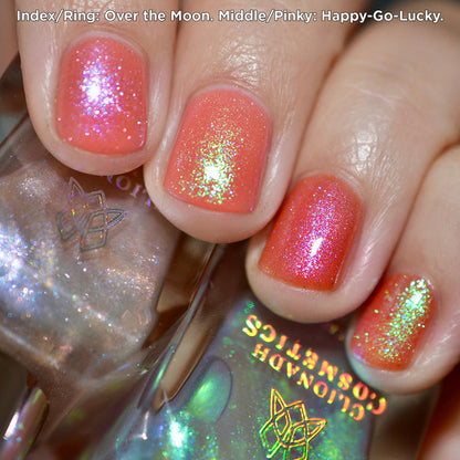 Close-up of nails painted with Over the Moon and Happy-Go-Lucky Nail Lacquers over an orange base on fair skin tone.