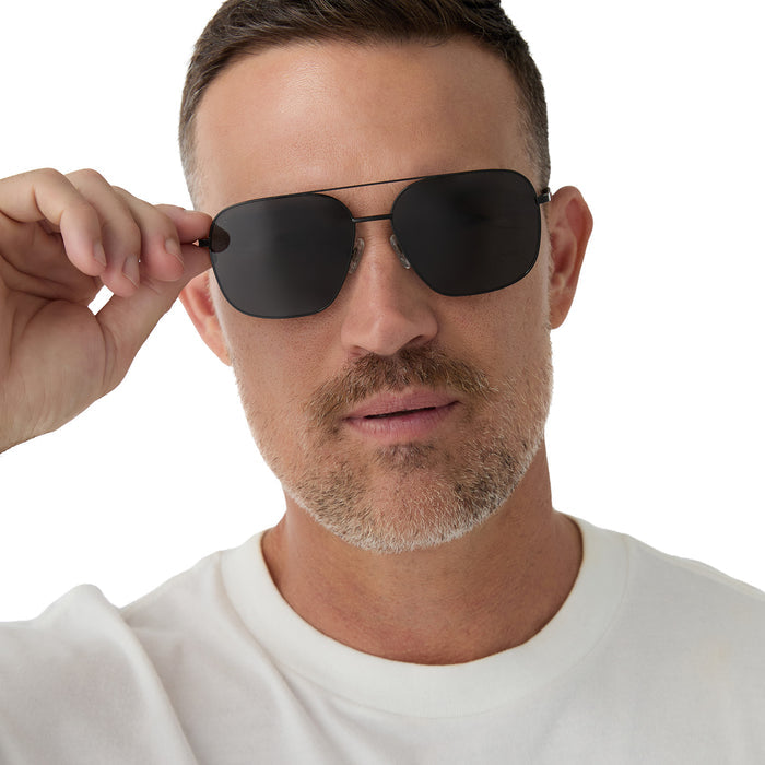 on model - male wearing diff eyewear jonas aviator prescription sunglasses with a black frame and grey polarized lenses front view