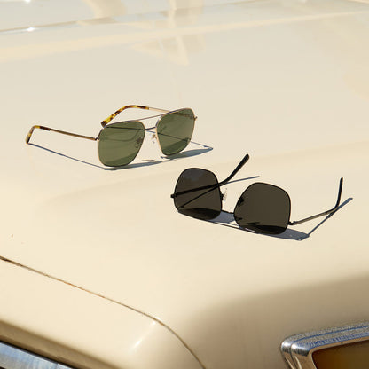 group shot of jonas gold and black sunglasses on top of a car hood