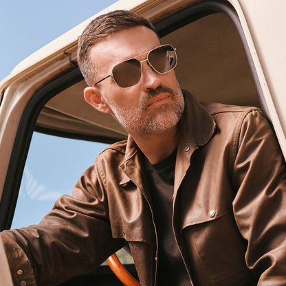 lifestyle - on male model wearing diff eyewear jonas aviator prescription sunglasses with a gold frame angled view