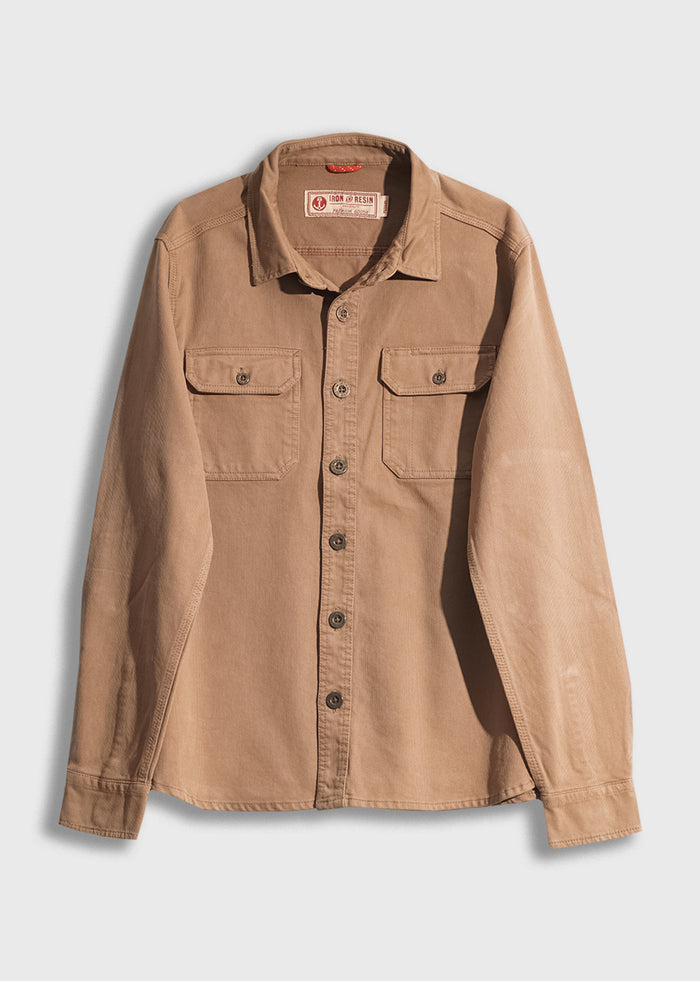Tan button-up shirt with two chest pockets and long sleeves, displayed on a white background.